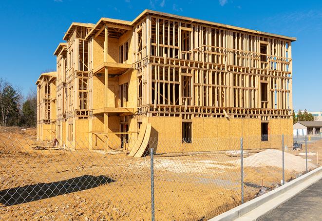 a close-up of temporary chain link fences enclosing a job site, signaling progress in the project's development in Parkland